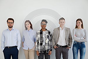 Group of young business people standing looking at camera
