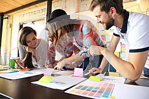 Group of young business people , Startup entrepreneurs working on their venture in coworking space.