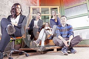 Group of young business people takes a moment to relax