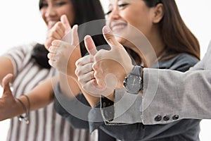 Group of young business people thumb up