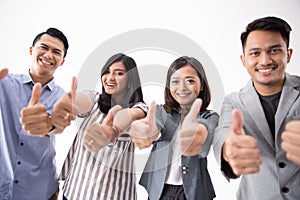 Group of young business people thumb up