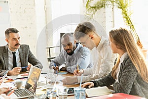 Group of young business professionals having a meeting, creative office