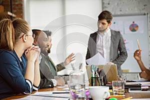 Group of young business professionals having a meeting, creative office