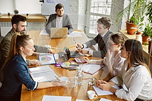 Group of young business professionals having a meeting, creative office