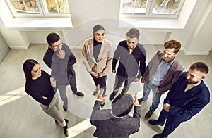 Group of young business professionals standing together and communicating