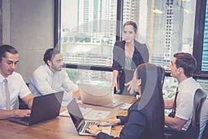 Group of young business team with woman manager standing leader meeting in conference room