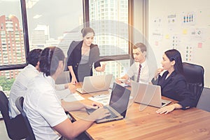 Group of young business team with woman manager standing leader meeting in conference room