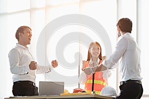 Group of young businessman and woman engineer celebrating success and show exiting achievement in brightness office atmosphere.