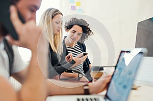 Group of young businesspeople with laptop working together in a modern office.