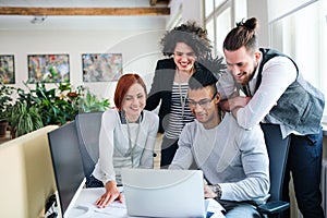 Group of young businesspeople working in office, start-up concept.