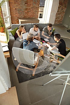 Group of young caucasian office workers have creative meeting to discuss new ideas