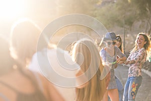 Group of young cheerful happy woman play with a cord all together for sumer leisure activity outdoor - playful and happiness