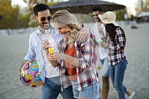 Group of young cheerful people bonding to each other and smiling