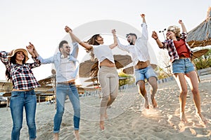 Group of young cheerful people bonding to each other and smiling