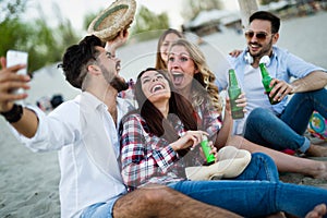 Group of young cheerful people bonding to each other and smiling