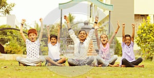 Group of young children cheering up at park - teens having fun during summer vacation - Multi ethnicity children playing