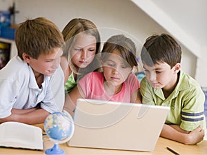 Group Of Young Children Doing Their Homework