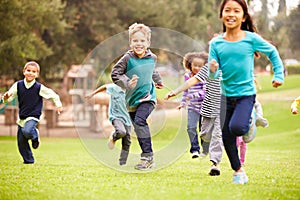 Group Of Young Children Running Towards Camera In Park