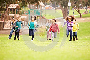 Group Of Young Children Running Towards Camera In Park