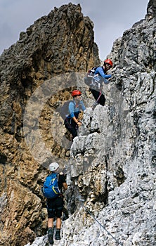 Group of young climbers on a steep vertical Via Ferrata