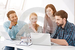 Group of young colleagues having meeting at office