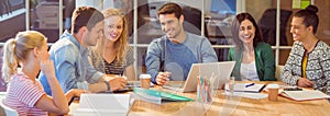 Group of young colleagues using laptop