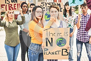 Group of young demonstrators on road, people from different culture and race fight for climate change - Global warming and