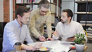 Group of young designers working on a drawing tablet.