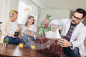 Young doctor during home visit senior people