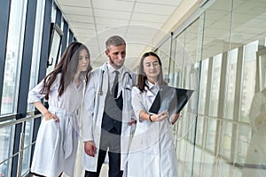 Group of young doctors discuss and looking x-ray scan leg in a clinic