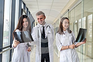 Group of young doctors discuss and looking x-ray scan leg in a clinic