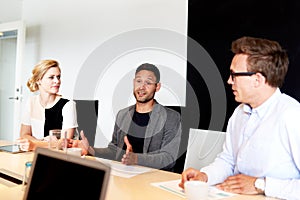 Group of young executives sitting in conference room
