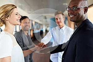 Group of young executives smiling before teamwork