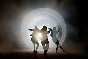 Group of young female dancers on the street at night