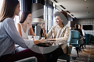 Group of young female friends meeting in cafe