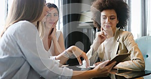 Group of young female friends meeting in cafe