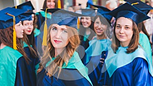 A group of young female graduates. Female graduate is smiling against the background of university graduates