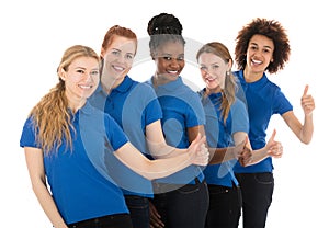 Group Of Young Female Janitors Gesturing Thumbs Up