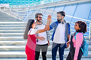 group of young female and male college students on campus