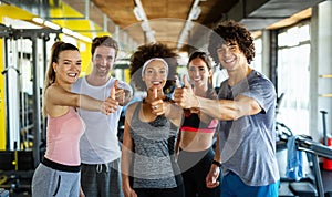 Group of young fit people, friends doing exercises in gym to stay healthy. Sport, people concept.