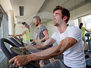 Group of young friends doing exercises in gym