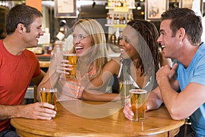 Group of young friends drinking and laughing