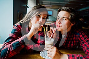 Group of young friends hanging out at a coffee shop. Young men and women meeting in a cafe having fun and drinking coffee. Lifesty