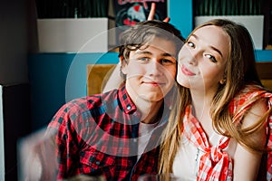 Group of young friends hanging out at a coffee shop. Young men and women meeting in a cafe having fun. Lifestyle, friendship and u