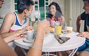 Group of young friends having breakfast at home