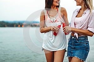 Group of young friends having fun at the beach on vacation party. People happiness concept