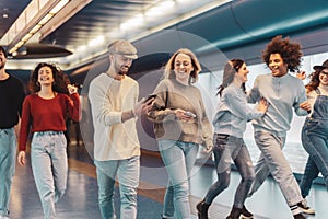 Group young friends having fun in subway underground metropolitan - Happy trendy people sharing time and laughing together