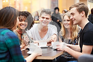 Group Of Young Friends Meeting In Cafe