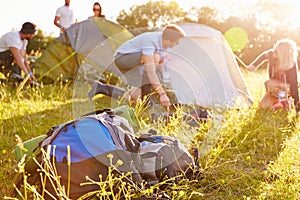 Group Of Young Friends Pitching Tents On Camping Holiday