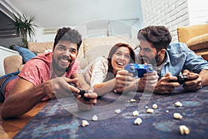 Group of young friends play video games together